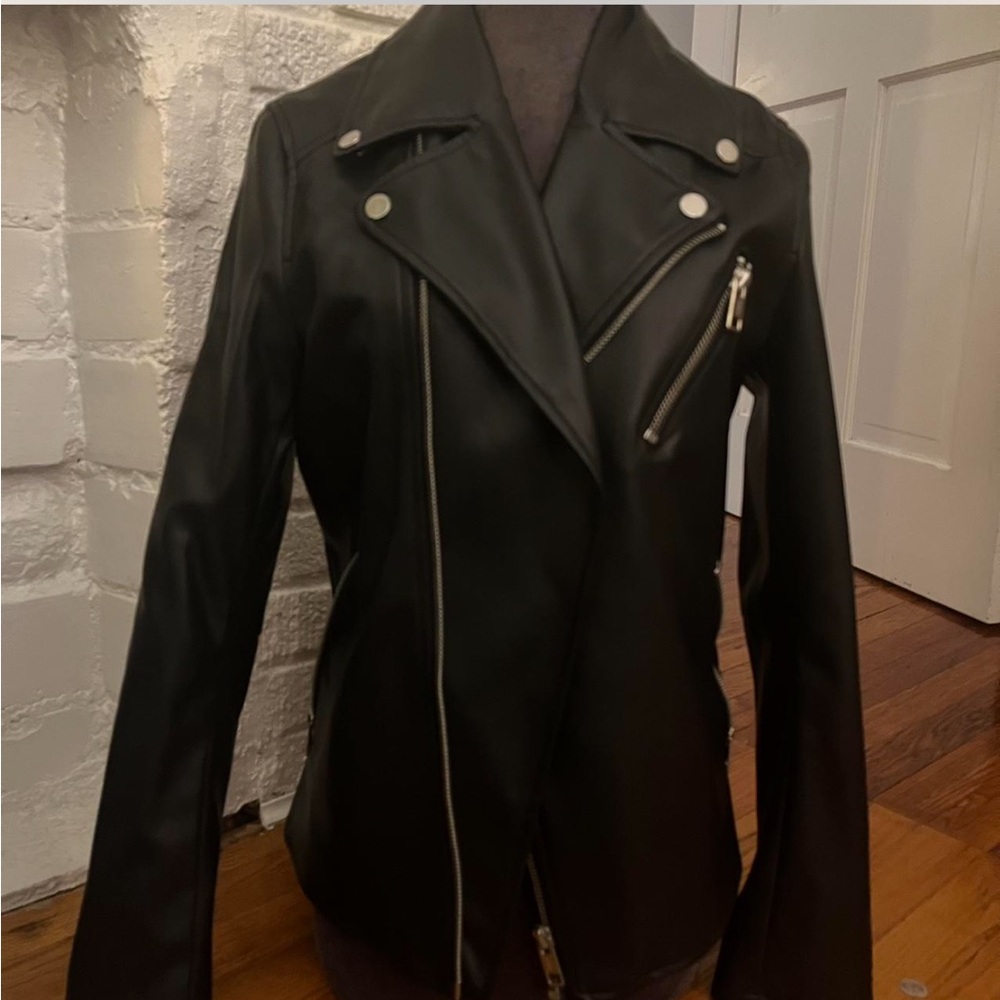 Black leather jacket with lots of silver zipper pockets